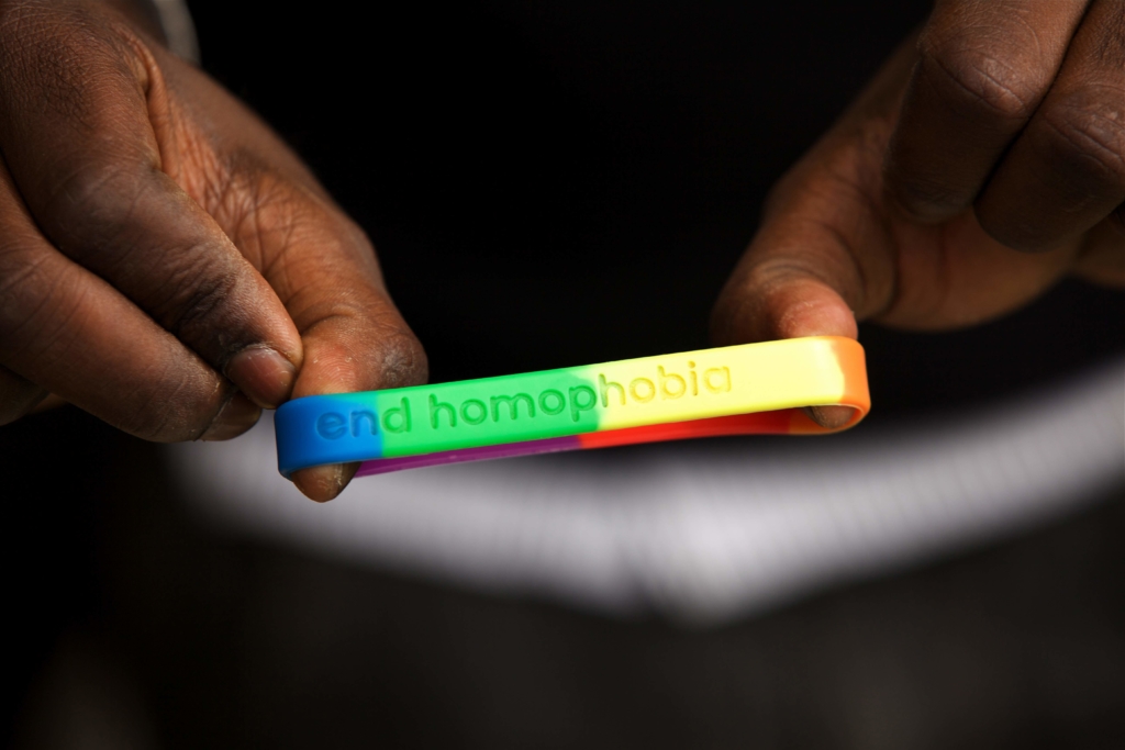 Two people hold an "End Homophobia" wrist band for World AIDS Day in Nairobi, Kenya, December 2010.