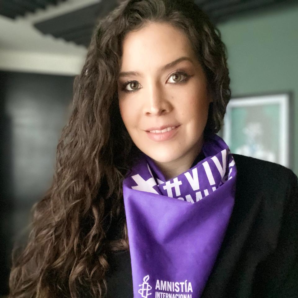 Portrait of Marcela Villalobos, wearing a purple Amnesty International scarf.