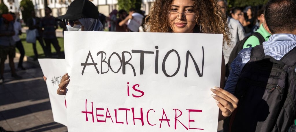 Moroccan activists demonstrate with a sign reading "Abortion is healthcare"