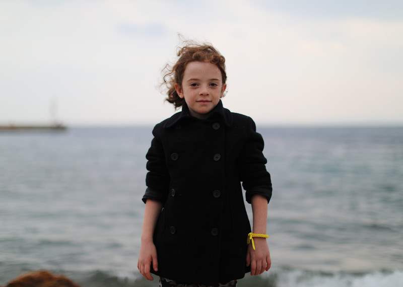 Sarah, aged six, pictured on the Greek island of Chios, 28 November 2016. She can name the capitals of almost all countries in the world. Sarah and her family fled bombing in her home city of Homs. They told Amnesty International that when they tried to cross the border between Syria and Turkey, Turkish police fired shots at them.