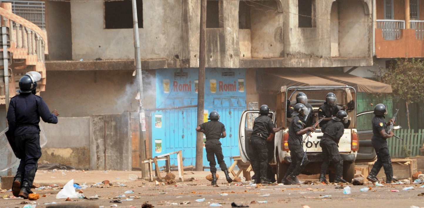 Police officers carrying firearms during a demonstration in the Cosa neighbourhood in Ratoma district, Conakry, on 13 April 2015.