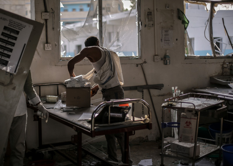 Hospital workers salvage undamaged medication and equipment from the emergency room at Abs Rural Hospital. The hospital offered vital health services in a country where access to health care is minimal. © Rawan Shaif