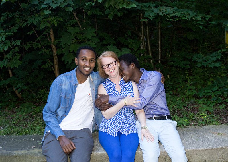 Mohamed Farah from Somalia and Yayha Adam from Sudan with one of their sponsors, Catherine LeBlanc Miller, Toronto, Canada, June 2017. ©Stephanie Foden/Amnesty International