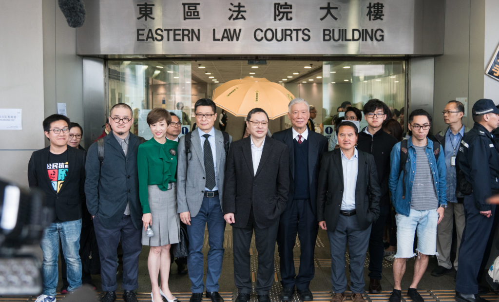 Nine leaders of Occupy Central and Umbrella Movement stand outside the Eastern District Court, Hong Kong, March 2017. © Raphael Wong Ho-ming.