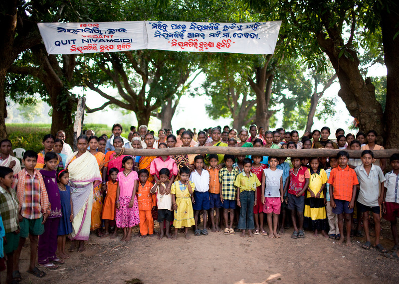 Kondh villagers stand next to the makeshift gate they've set up to stop Vedanta officials from accessing the proposed mining area. Credit: Sanjit Das.