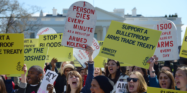 Demonstrators from Amnesty International chant outside the White House in Washington, DC ©AFP/Getty Images.