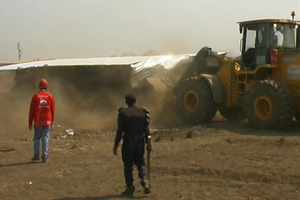 A bulldozer demolishes a building during the eviction of hundreds of residents at Kawama, DRC, 24 November 2009. © Jeff Mbiya