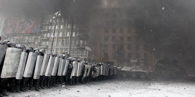 Riot police line up with shields on a fourth day of violent confrontation against protesters in Kiev, Ukraine in January 2014.© Anatolii Stepanov/Demotix/Corbis.