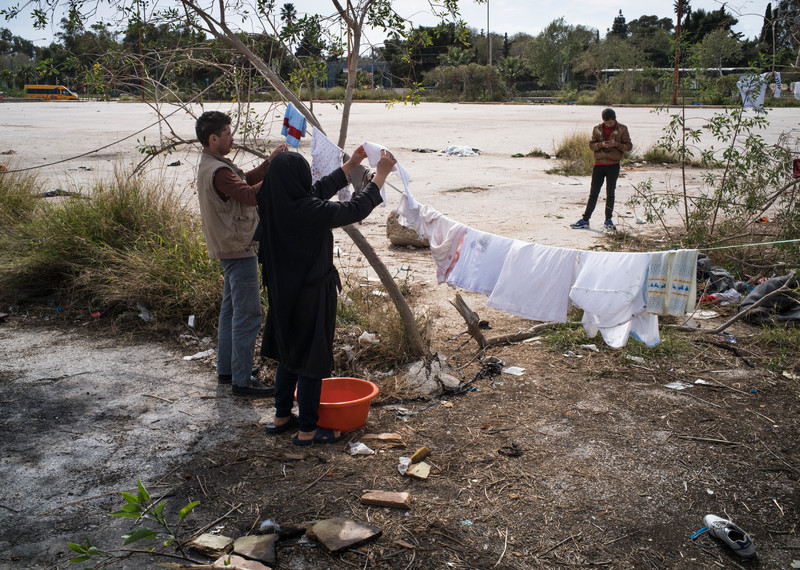 People wash and hang their clothes in the open air outside the old airport, in a desperate attempt to freshen up. Clothes and rubbish are strewn around them, remnants of kind, but random voluntary donations that don’t always reach those who need them most. © Amnesty International/Olga Stefatou