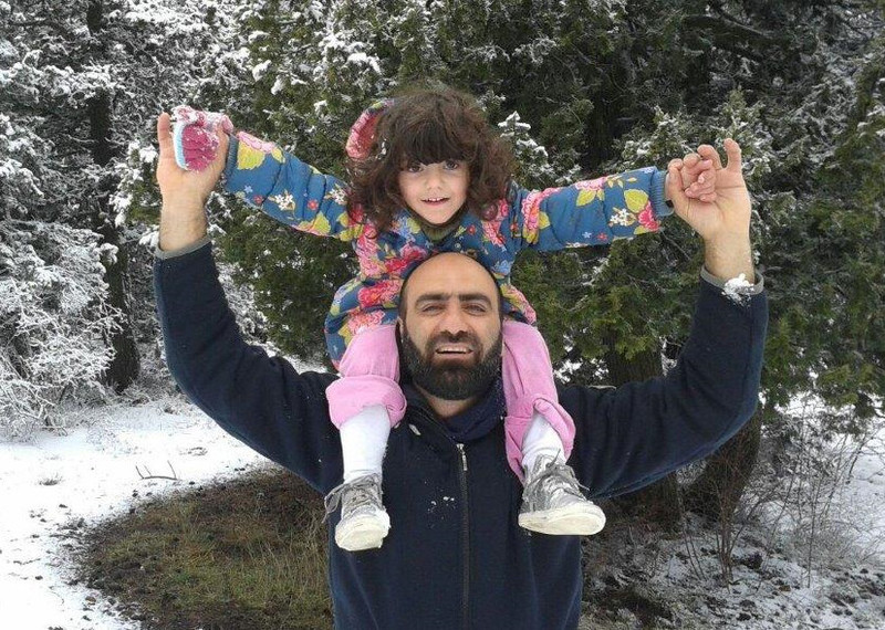 Ahmed H playing with his daughter in the snow.