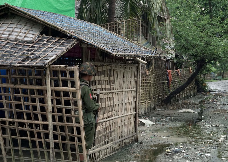 A Myanmar soldier looks down a deserted street in a Muslim area in central Maungdaw on August 31, 2017.