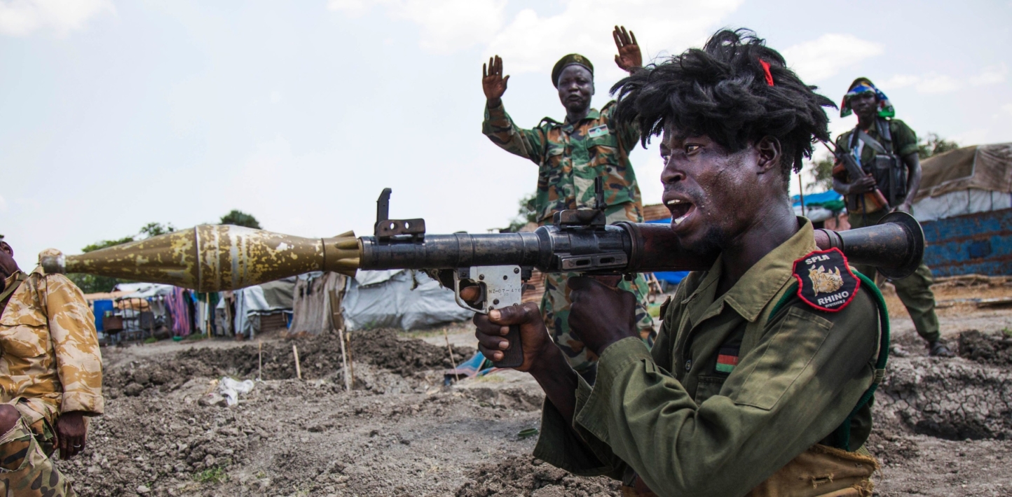 soldiers of the Sudan People Liberation Army (SPLA) celebrate while standing in trenche