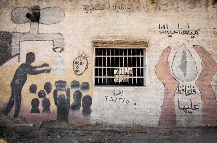 A mural painted on the wall of a disused pumping station beside route 90, the main highway which stretches the length of the Jordan Valley. The writing reads, 'Our water is our life so let’s preserve it”. In the Jordan Valley numerous springs and wells have been made redundant as the Mountain Aquifer on the western edge of the valley is increasingly exploited by the Israeli-state owned company Mekorot. © Amnesty International