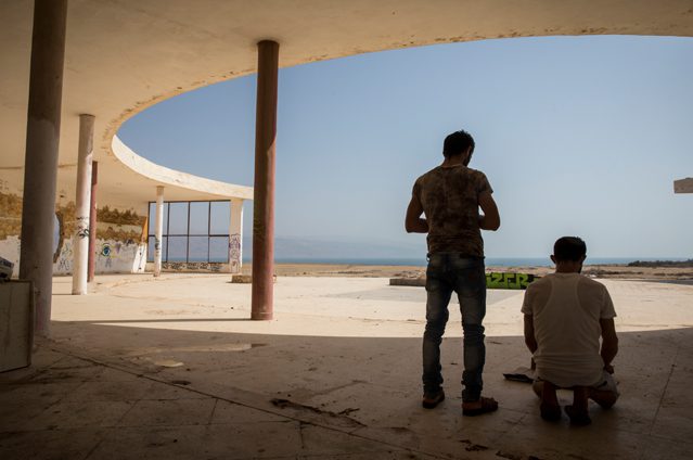 Palestinian tourists from Nablus pray in an abandoned lido near the Dead Sea in the Jordan Valley. Since 1967, the Israeli authorities have denied Palestinians access to the Jordan River has been restricted entirely along its whole course through the West bank. Water levels in the Dead Sea have fallen dramatically over the past 50 years due to diversion of the river Jordan up stream by Israel as well as Jordan and Syria. The Dead Sea now lies around half a kilometre away from the lido when once it surrounded it. © Amnesty International