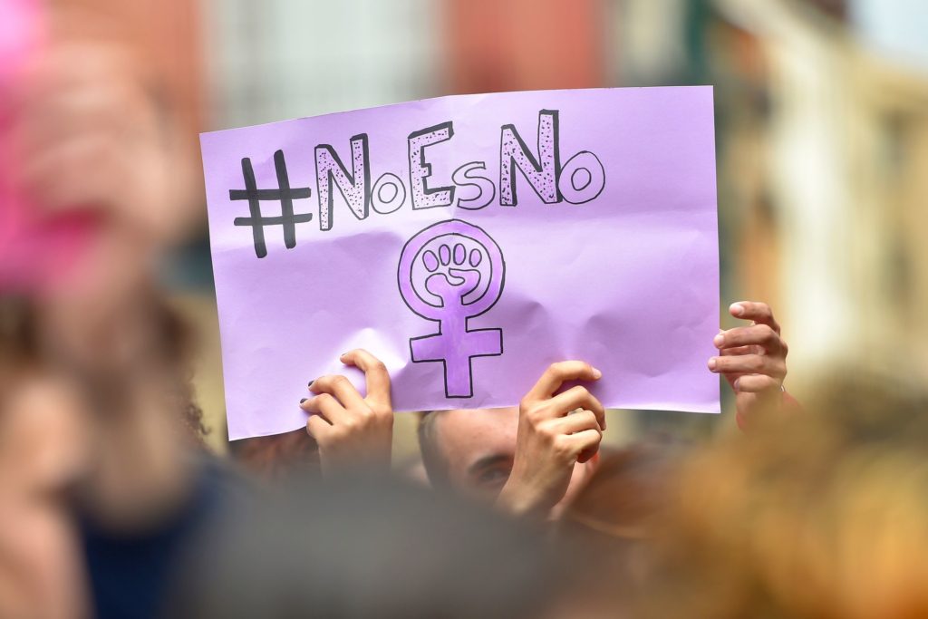 Protestors hold a sign reading 