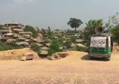 A tuktuk with megaphones attached to broadcast health advice about COVID-19 in the camps. © Al Jazeera English