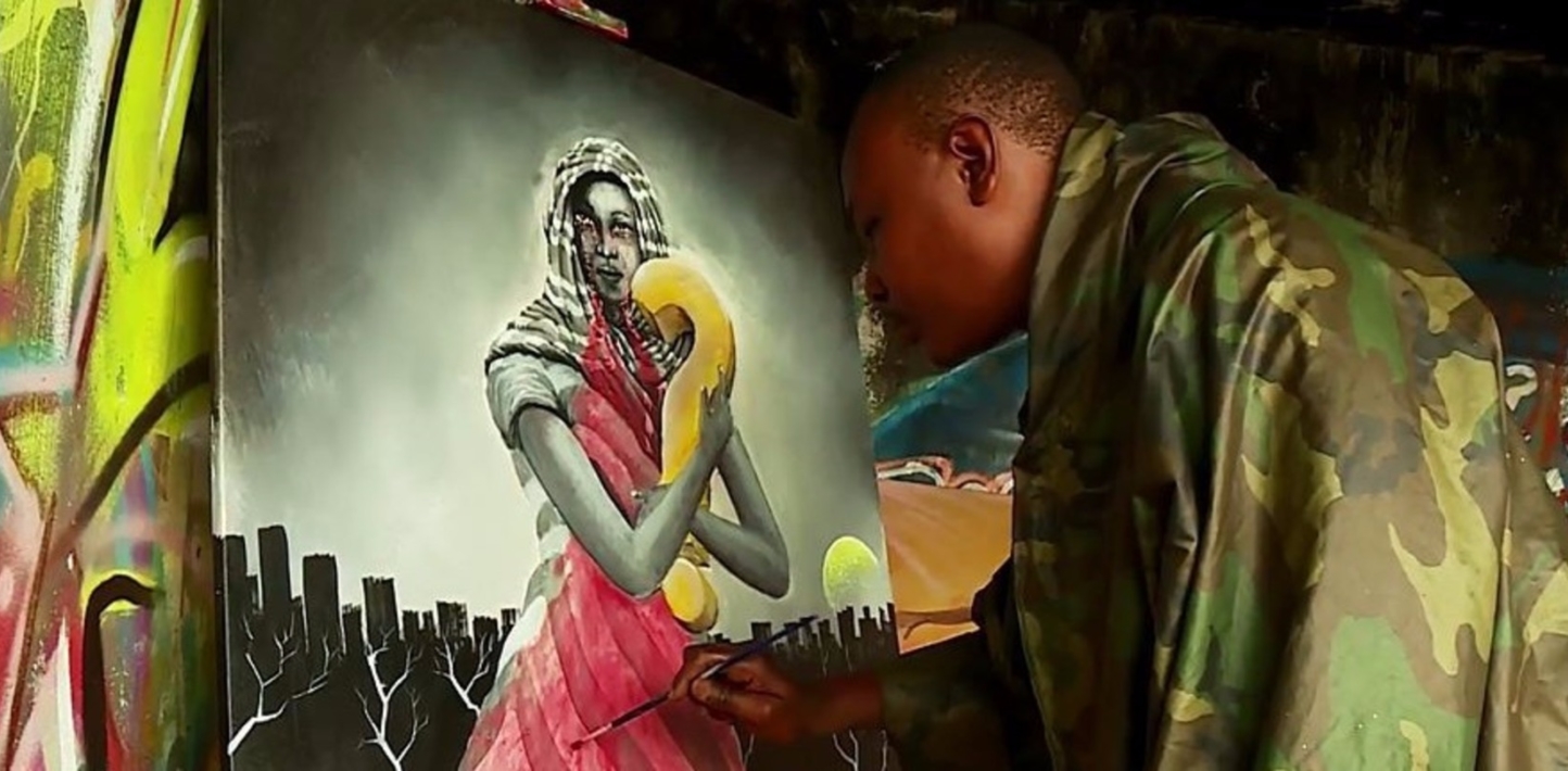 A man looking at a painting of a woman holding a big question mark carving. This image depicts an enforced disappearance.