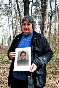 Hristina Stoyanova holds a photograph of her son, Mihail Stoyanov, in Borisova Garden where he was murdered in September 2008. © Amnesty International