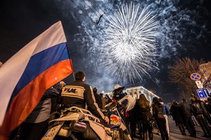 Pro-Russian protesters attend a rally in Simferopol, Crimea following the region being formally annexed by the Russian Federation on 21 March 2014. © DMITRY SEREBRYAKOV/AFP/Getty Images