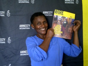 Diana Nyakowa holding the Sept/Oct issue of Amnesty's global magazine, WIRE, which has her picture on the cover. © Private