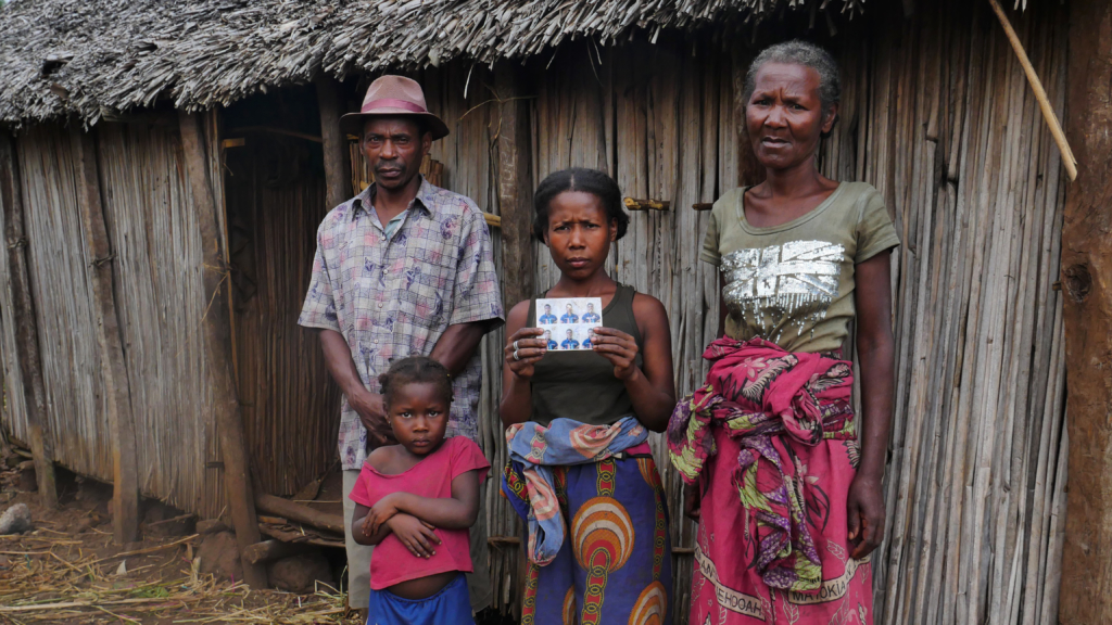 Ralista’s uncle Charles, mother, wife and one of their three children in front of the family’s hut.