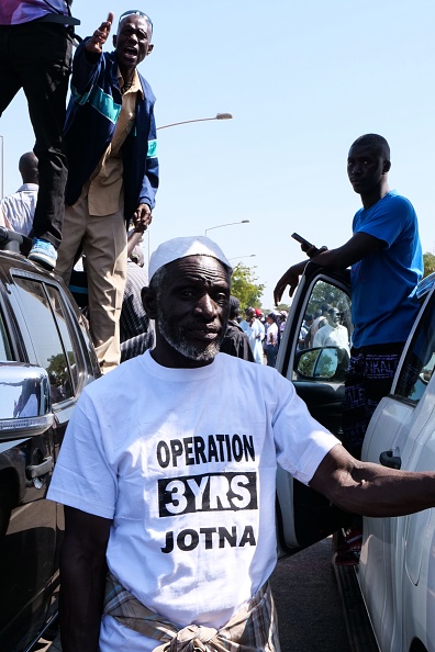 A protester wearing a tee shirt reading "Operation 3 Years Jotna" looks on during a demonstration against Gambian President, in Banjul, Gambia, on December 16, 2019. (Photo by Romain CHANSON / AFP) (Photo by ROMAIN CHANSON/AFP via Getty Images)