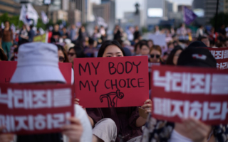 Protesters hold placards reading 'Abolish punishment for abortion' as they protest South Korean abortion laws in Gwanghwamun plaza in Seoul on July 7, 2018.