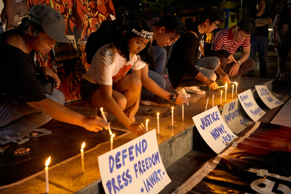 Journalists and activists gather to hold a vigil on the eve of the promulgation of the Ampatuan massacre trial on December 18, 2019 in Manila, Philippines. After a ten year trial, a judgement will be handed down this week in the November 23, 2009 massacre of 58 people, including 32 journalists, on their way to a local political event at Ampatuan, Maguindanao. The victims were rounded up by armed gunmen working for the Ampatuan clan and executed in what is the deadliest single attack on journalist in the world.