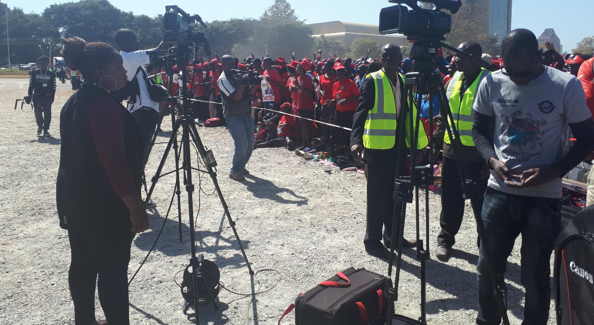 Journalists covering a campaign rally in Zimbabwe