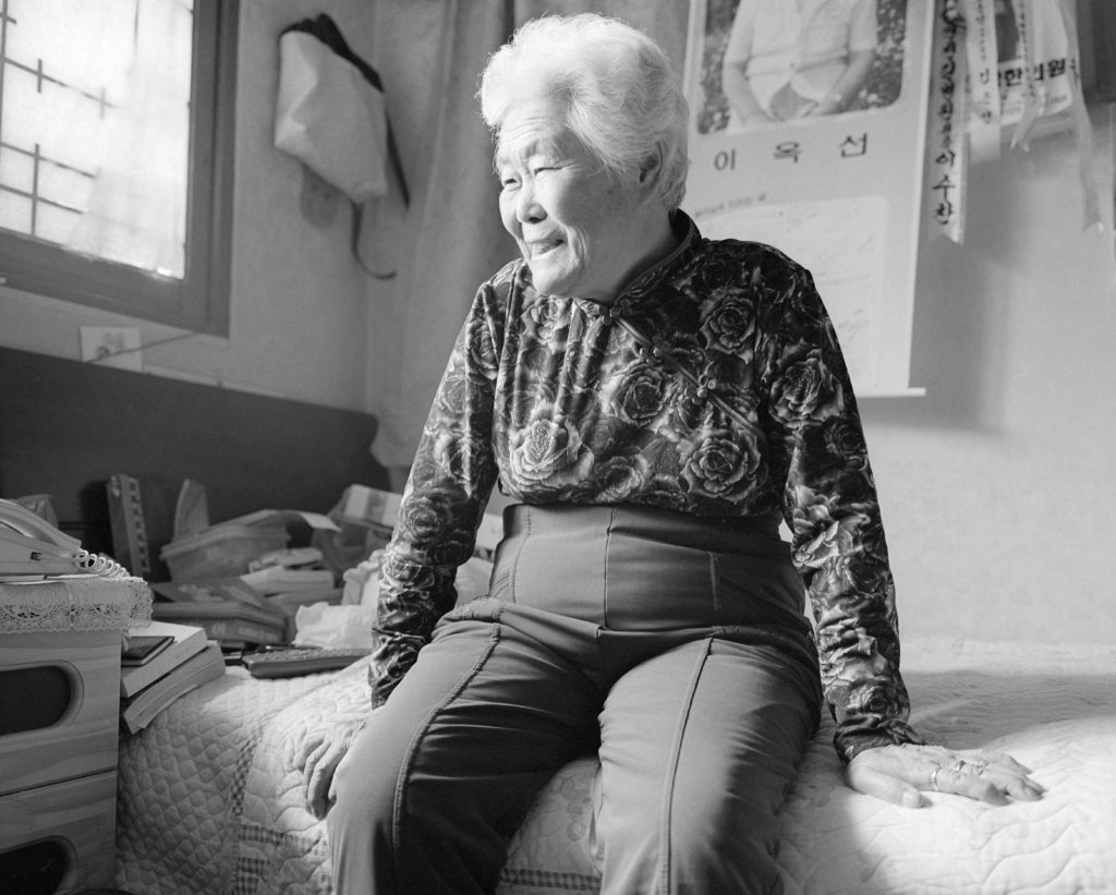 “I couldn’t get pregnant, I couldn’t even think about having a baby, I got diseases which impacted my ability to have children...,” Lee Ok-sun, 89. Copyright Paula Allen.