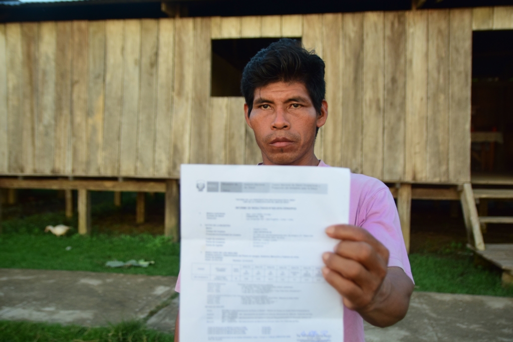 Percy Casternoquea Cariajano, a resident of Cuninico, with result of his test results confirming he has heavy metals in his body. Photo: Kat Goicochea / Amnesty International, 2017