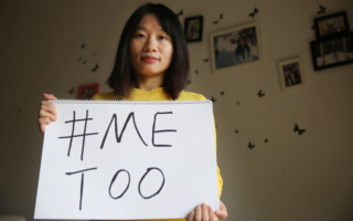 Sophia Huang holds up a #MeToo sign