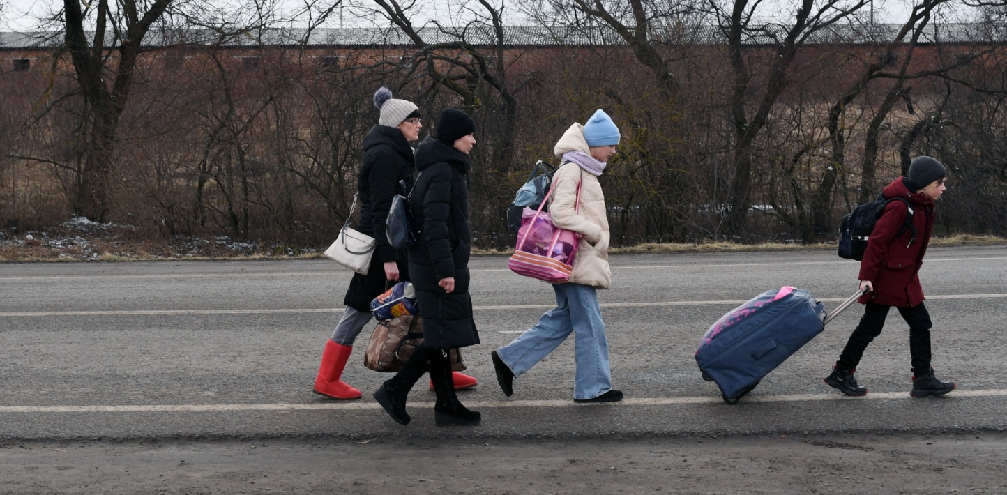 An Ukrainian family walks towards the Medyka-Shehyni border crossing between Ukraine and Poland as they flee the conflict in their country.