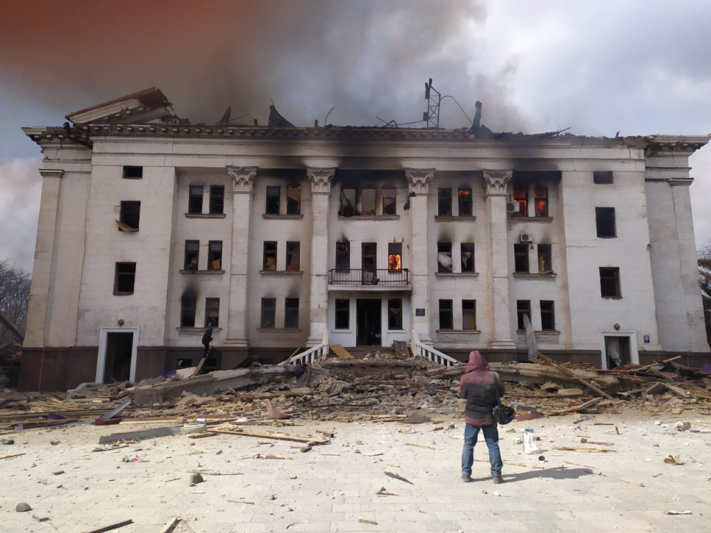 Serhii Zabohonskyi, stands outside the rear of the theatre moments after the explosion.