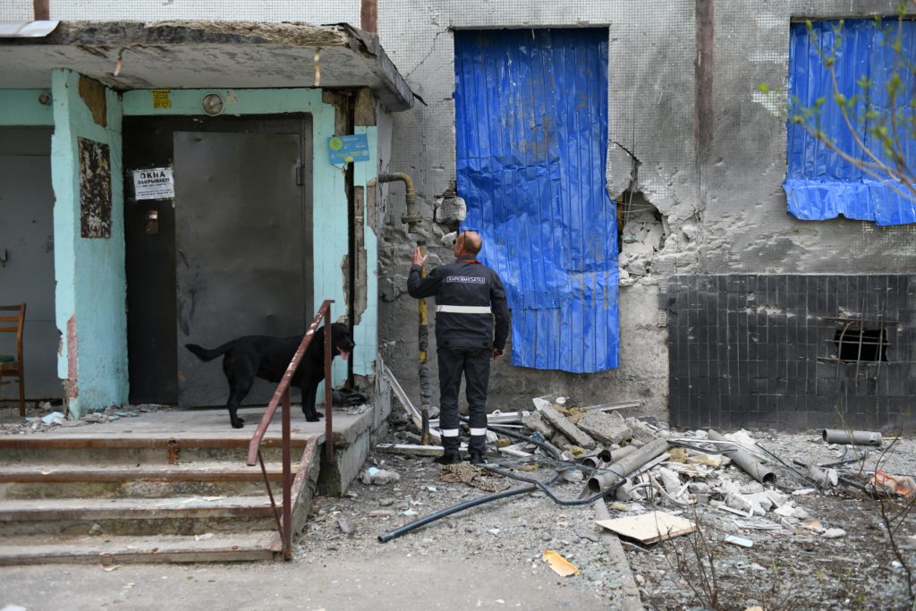 A workman repairing some of the damage caused by multiple Grad rockets strikes around the building on 23 April 2022