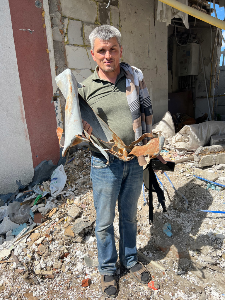 Andrii Mykolaiovych, a church worker, shows the remains of the Grad rocket which destroyed his home on 28 February or 1 March 2022.