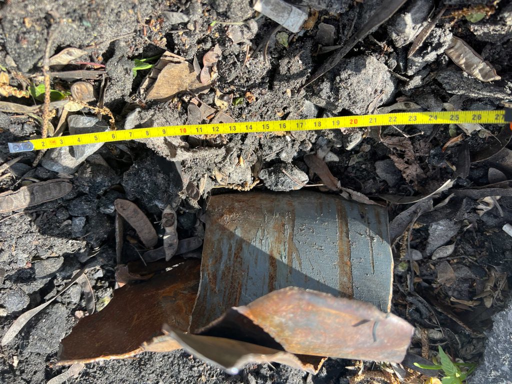 Crater with remain of rocket which exploded near a crowd of people queueing for humanitarian aid on 24 March 2022.