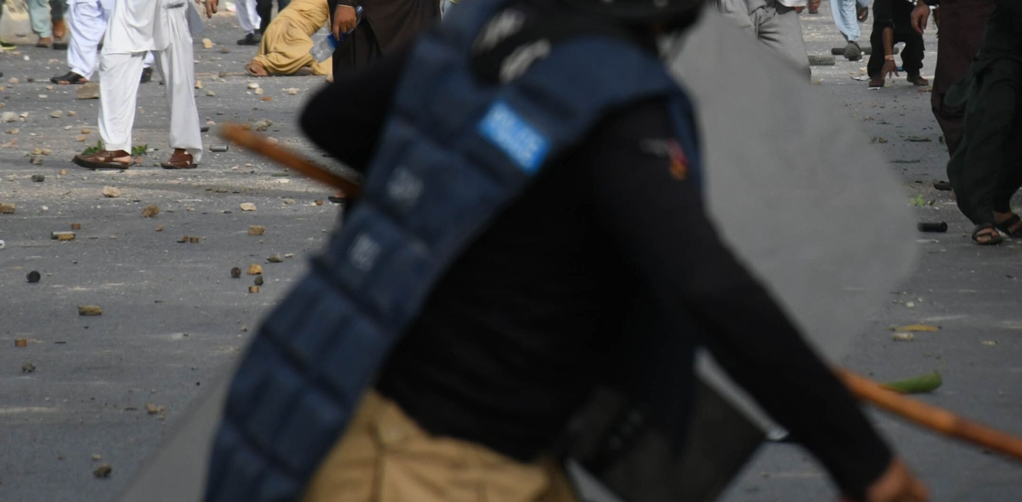 Representative picture of police official with baton at protest site in Pakistan