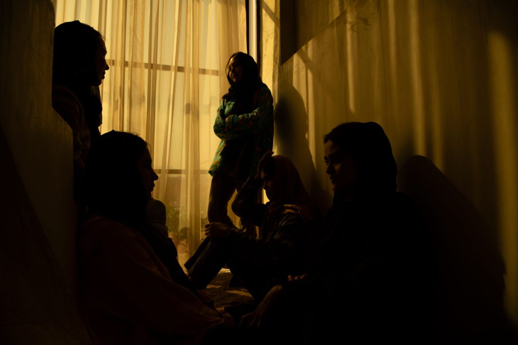 An Afghan woman poses for a portrait in her home. 