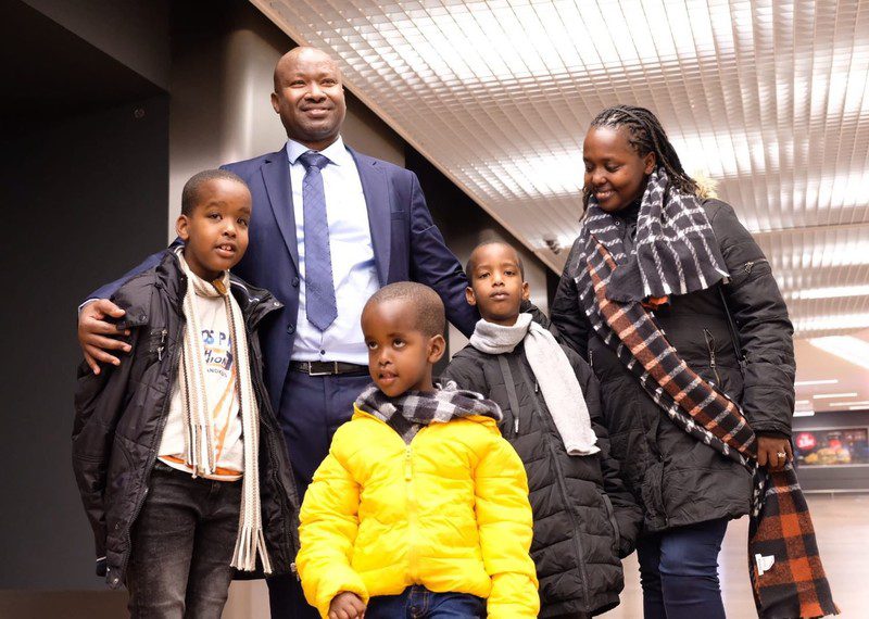 A family standing together in an airport.