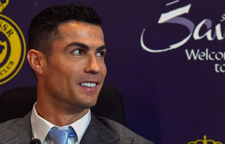 Cristiano Ronaldo at a press conference, sitting in front of a banner that says 'welcome to Saudi Arabia' 