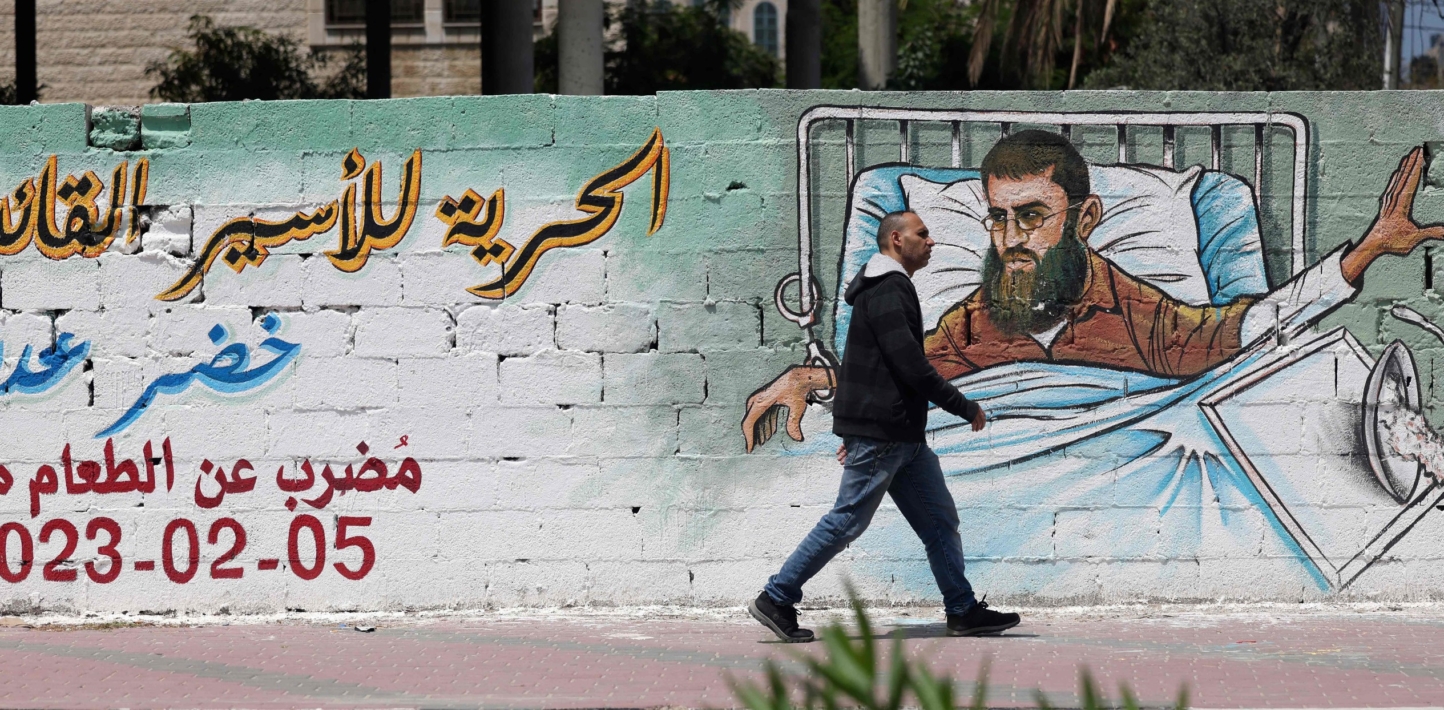 A wall with street art depicting the hunger-striking prisoner Khader Adnan.