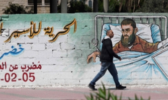 A wall with street art depicting the hunger-striking prisoner Khader Adnan.