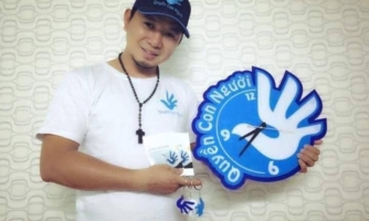 Bui Tuan Lam holds up a clock