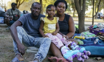 Samuel, 32, with his wife Louis, 29, and their daughter Ludelaura, 3, from Haiti, are pictured in a makeshift encampment where Haitian migrants, who had been waiting to claim asylum in the United States, have moved to in Parque Ecologico Braulio Fernandez in Ciudad Acuna, Coahuila state, Mexico on September 22, 2021