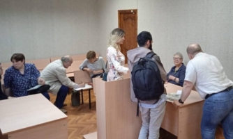 Russian human rights defender Tatyana Kotlyar in a court room after conviction surrounded by lawyers and supporters.