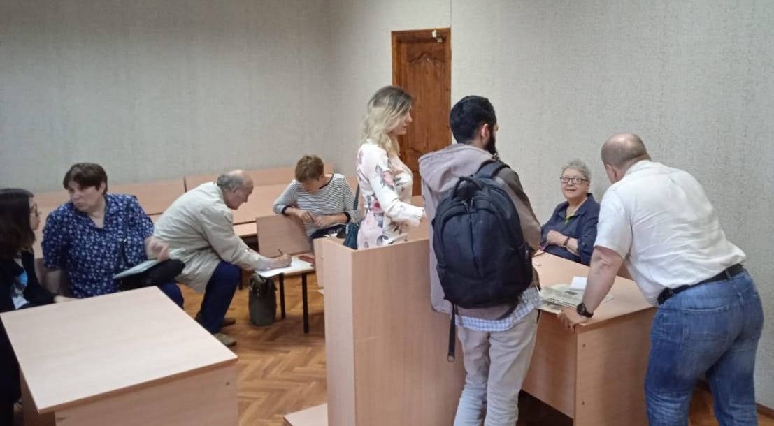 Russian human rights defender Tatyana Kotlyar in a court room after conviction surrounded by lawyers and supporters.