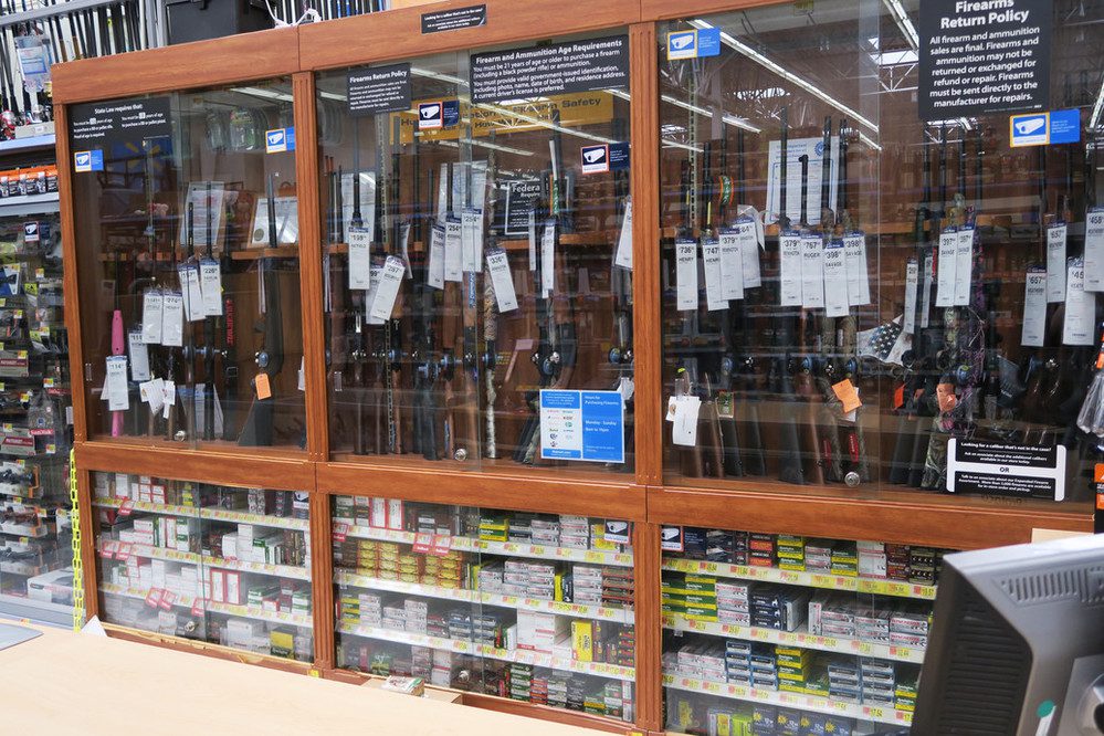 A gun cabinet at a store selling rifles and ammunition.