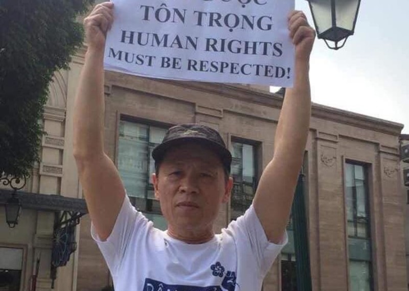 Activist Truong Van Dung holds up a protest sign