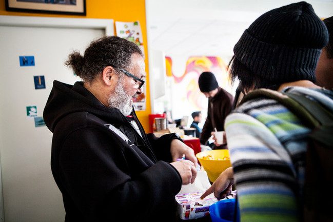 one of the staff members at Pause Diabolo hands out medication and sterile equipment as part of the centers harm reduction programme.